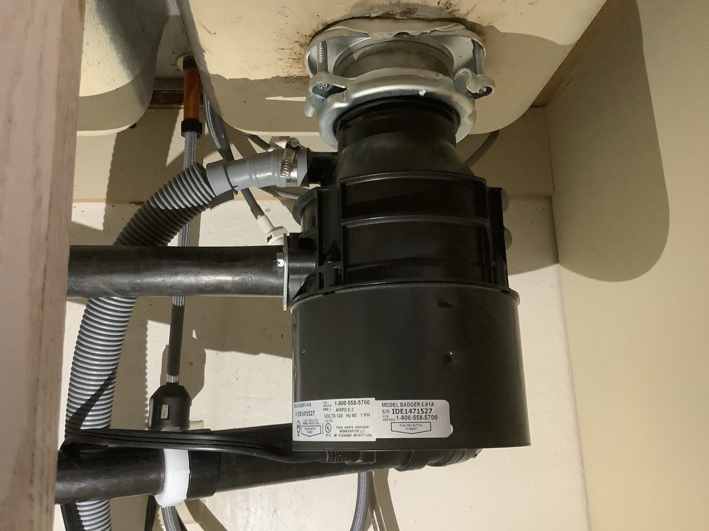 New garbage disposal installation under kitchen sink