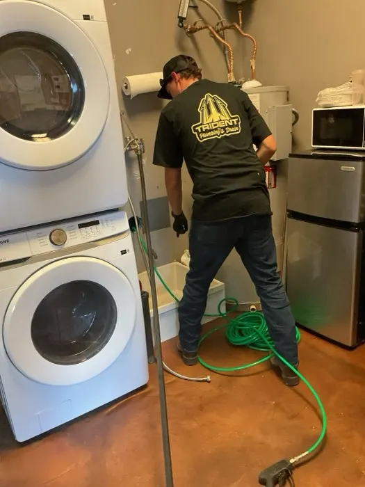 Trident technician hydro jetting a residential drain line