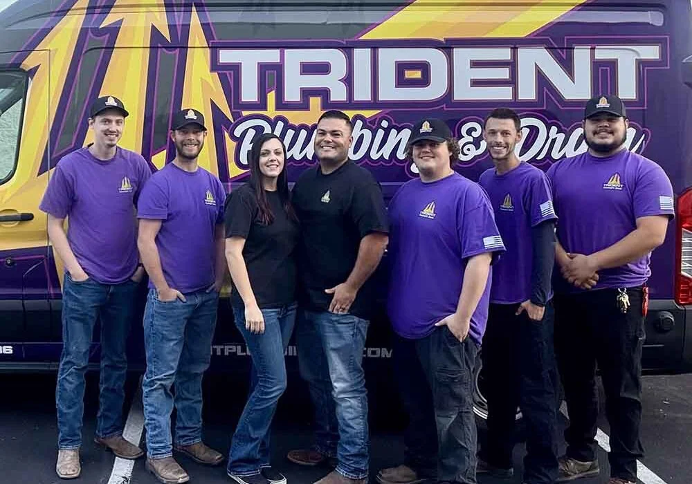 The Trident Plumbing & Drain team in front of their service van