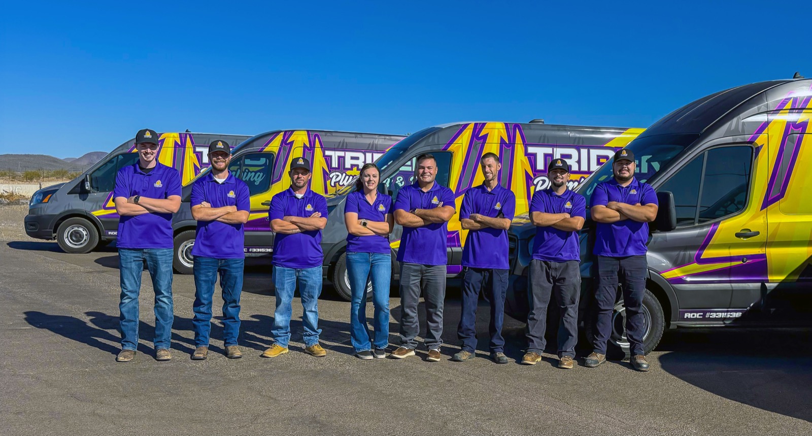 The Trident Plumbing & Drain team in front of the company fleet — eight technicians serving Greater Phoenix.